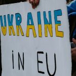 a person holding a sign that says ukraine in eu